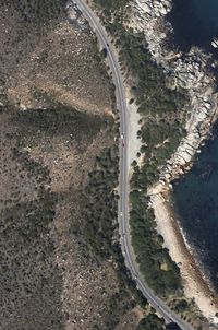 Aerial view of winding road on mountain by sea