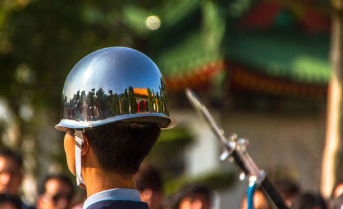 Close-up of soldier wearing helmet with reflection during parade on sunny day