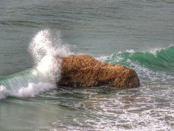 Sea waves splashing on rocks