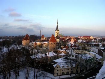 Buildings in city against sky during winter