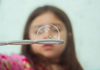 Close-up of girl holding bubble wand