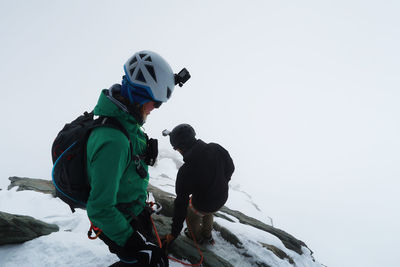 Couple on snowcapped mountain