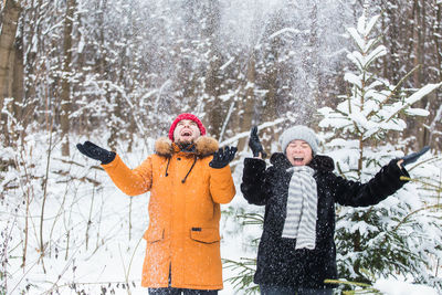 View of people on snow covered landscape during winter