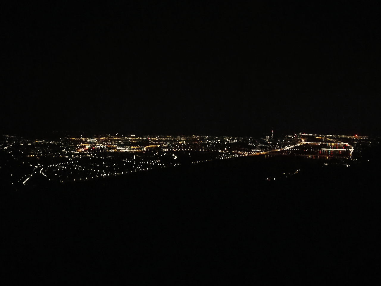 AERIAL VIEW OF ILLUMINATED BUILDINGS IN CITY