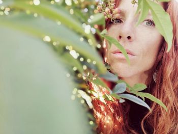 Portrait of woman seen through plants