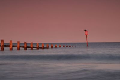 Scenic view of sea against clear sky at sunset