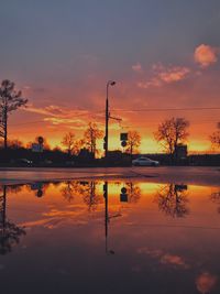 Scenic view of lake against orange sky