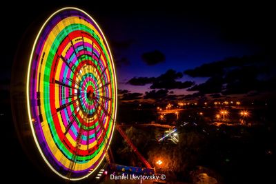 Illuminated ferris wheel at night