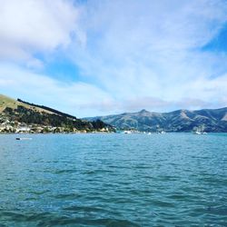 Scenic view of sea and mountains against sky