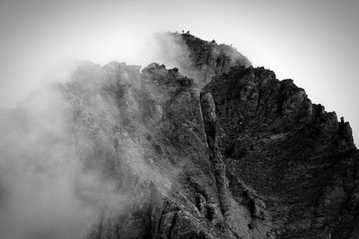 Low angle view of rock formation against sky