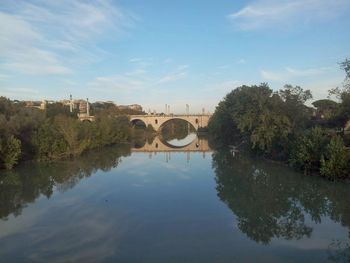 Bridge over river with city in background