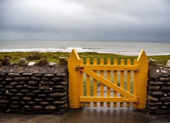 Lifeguard hut on beach against sky