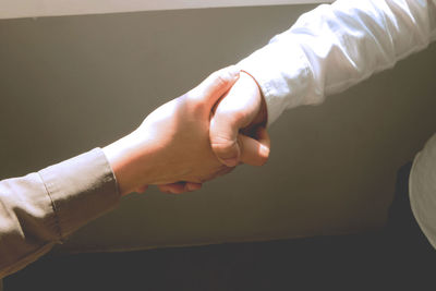 Close-up of man holding hands