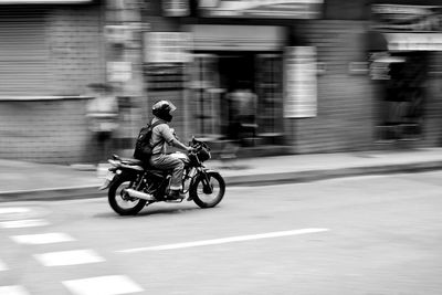 Man riding motorcycle on street