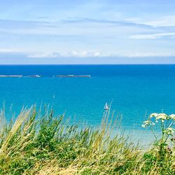 Scenic view of sea against cloudy sky