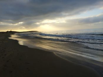 Scenic view of beach against sky during sunset