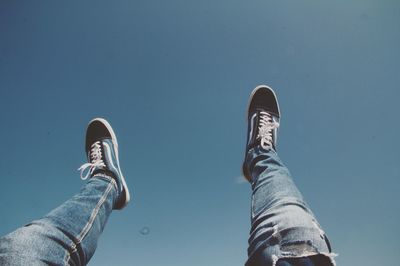 Low section of man against clear blue sky