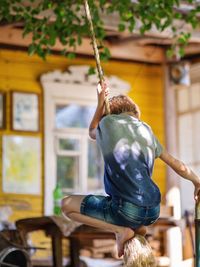 Rear view of man sitting outdoors