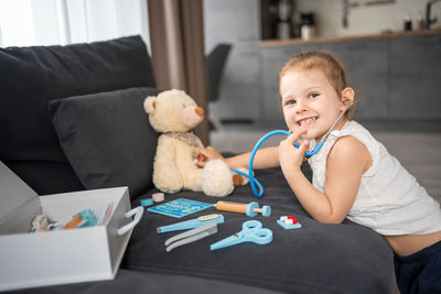 Portrait of cute boy with teddy bear at home