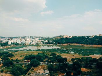 View of cityscape against cloudy sky