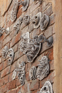 Decoration on the wall of an old house in the form of corrals. brick wall decor.