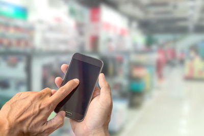 Midsection of man using mobile phone