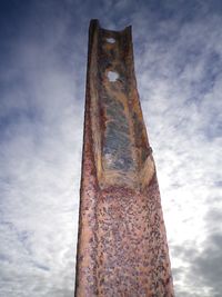 Low angle view of rusty metal against sky