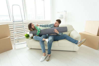 Young couple sitting on floor at home