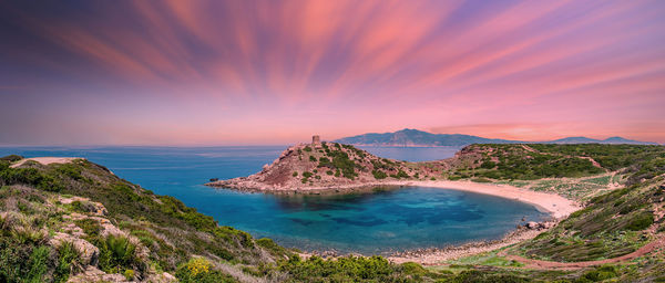 Panoramic landscape of porticciolo tower in spring at sunset with long exposure pink clouds