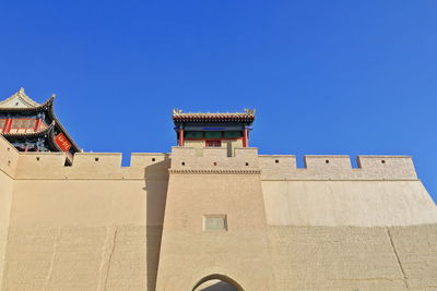 Low angle view of historic building against clear blue sky