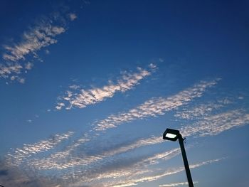 Low angle view of vapor trail against blue sky