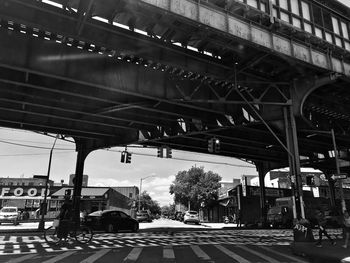 Cars on road against sky in city