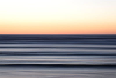 Scenic view of sea against clear sky during sunset