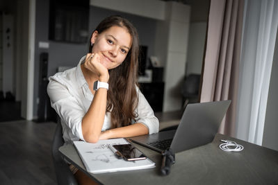 Young woman using laptop at home