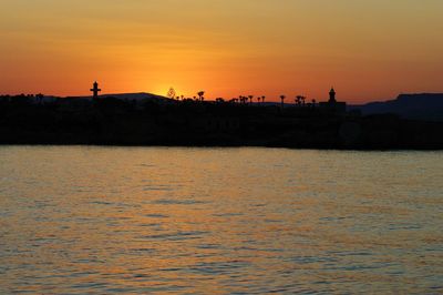 Scenic view of sea against orange sky