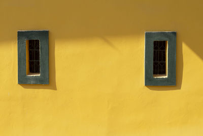 Low angle view of yellow window on building