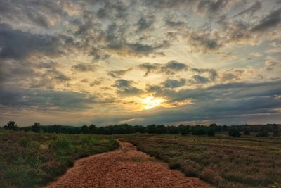 Scenic view of field against sky during sunset