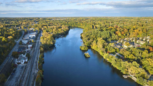 High angle view of river amidst field against sky