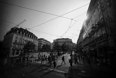 People walking on road along buildings