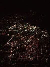 High angle view of city lit up at night