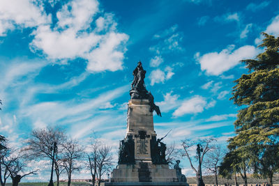 Low angle view of statue against cloudy sky