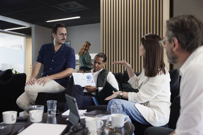 Group of business people having meeting in lobby