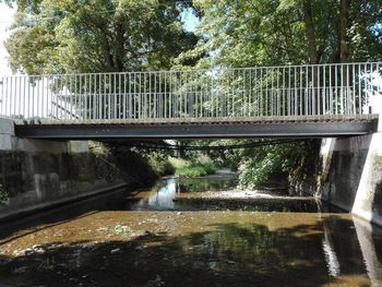 View of bridge over canal against trees