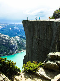 Scenic view of sea by cliff against sky