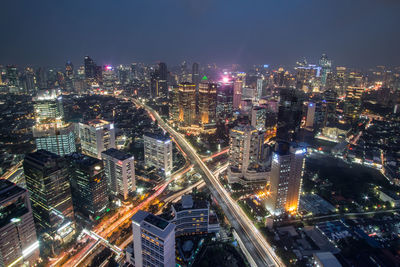 High angle view of illuminated city buildings at night