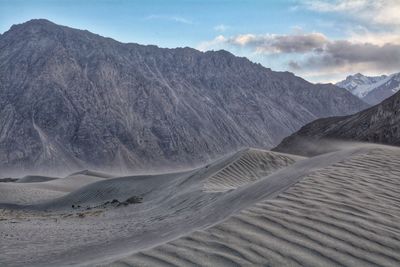 Scenic view of arid landscape against sky