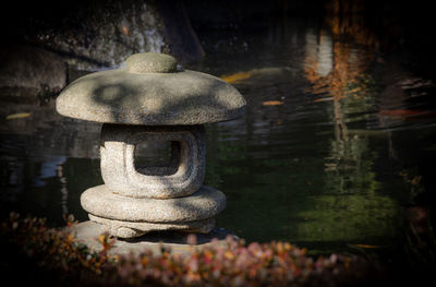 Close-up of stone structure in lake