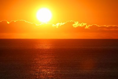 Scenic view of sea against orange sky