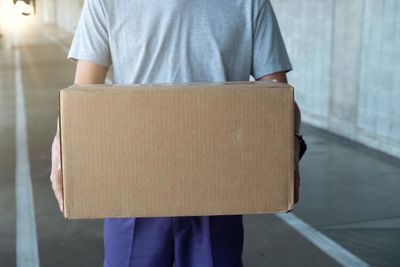 Midsection of man standing on paper