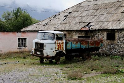 House on field with oldtimer in front